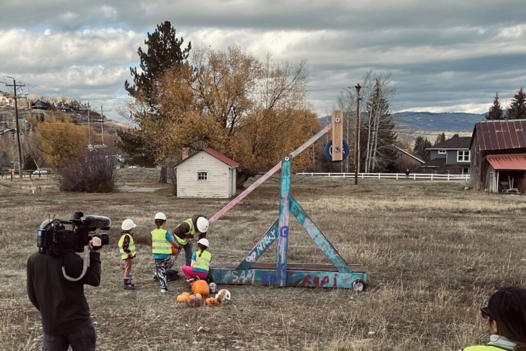 Montessori elementary students conducting a hands-on physics experiment outdoors